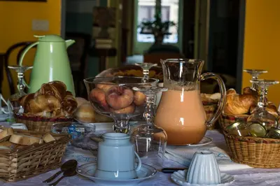 a table with baskets of fruit and a jug of juice at La dimora del genio in Palermo