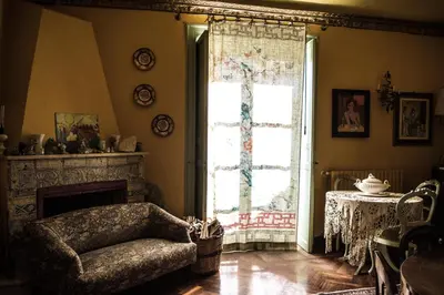 a living room with a chair and a fireplace at La dimora del genio in Palermo