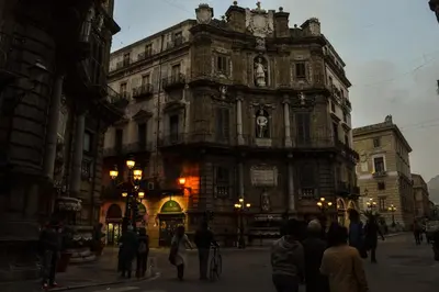 a group of people standing in front of a large building at La dimora del genio in Palermo