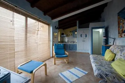 a living room with a couch and a chair at Balconi Sul Mare Appartamenti in Castellammare del Golfo