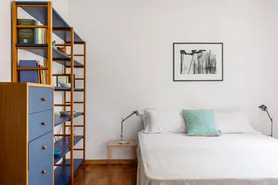 a bedroom with a bed and a book shelf at Villa Angelica by Wonderful Italy in Castellammare del Golfo