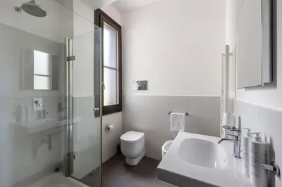 a white bathroom with a toilet and a sink at Villa Angelica by Wonderful Italy in Castellammare del Golfo
