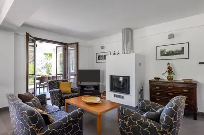a living room with chairs and a table and a tv at Villa Angelica by Wonderful Italy in Castellammare del Golfo