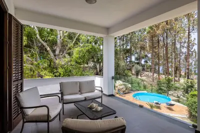 a patio with a couch and a table and a pool at Villa Angelica by Wonderful Italy in Castellammare del Golfo
