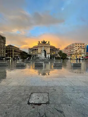 a building with a fountain in the middle of a plaza at Punto Politeama in Palermo