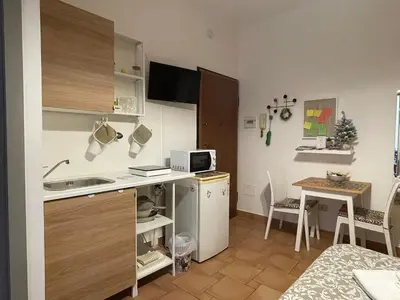 a small kitchen with a sink and a table in a room at Punto Politeama in Palermo