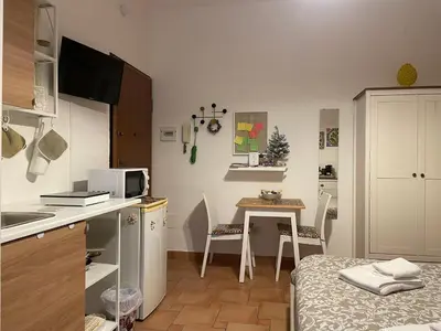 a small kitchen with a small table in a room at Punto Politeama in Palermo