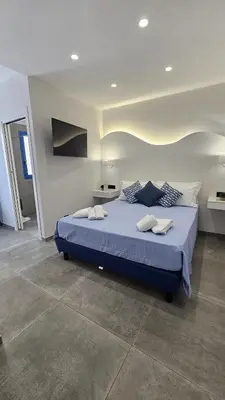 a bedroom with a large blue bed in a room at Panhouse in Palermo