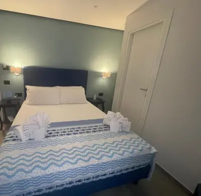 a bedroom with a bed with two towels on it at Panhouse in Palermo