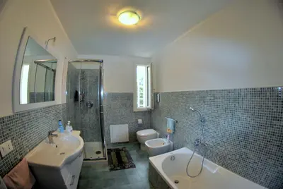 a bathroom with a sink and a tub and a toilet at Villa Ginevra in Mondello