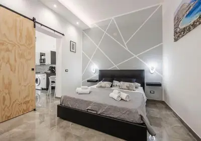 a bedroom with a large bed with towels on it at Onda blu in Palermo