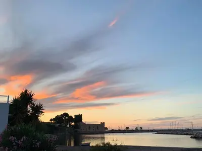 a sunset over a body of water at Daydream in Trabia