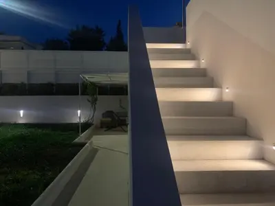 a staircase leading up to a house at night at Daydream in Trabia