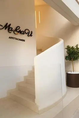 a staircase in a building with a sign on the wall at Ma Gra Ví in Terrasini