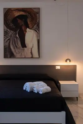a bedroom with a bed with two towels on it at Ma Gra Ví in Terrasini