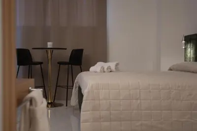 a bedroom with a bed and a table and chairs at Ma Gra Ví in Terrasini