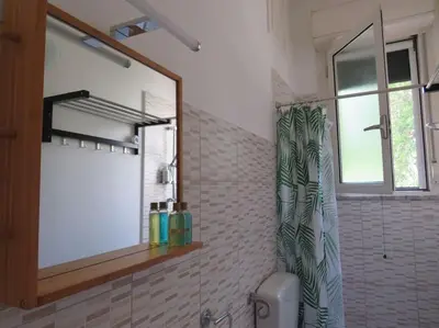 a bathroom with a mirror and a shower curtain at Relax nel verde- GioDaPi Palm in Palermo