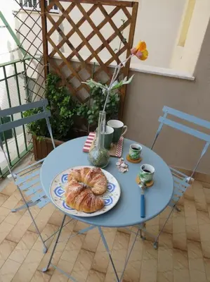 a blue table with a plate of bread on it at Relax nel verde- GioDaPi Palm in Palermo