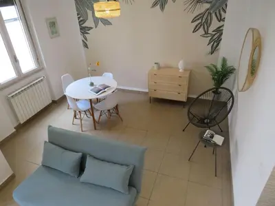 a living room with a couch and a table at Relax nel verde- GioDaPi Palm in Palermo
