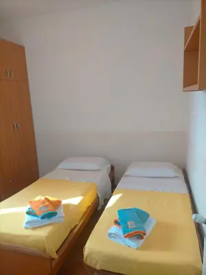 two beds in a room with towels on them at Menzel el Emir in Misilmeri