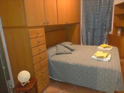 a small bedroom with a bed and a dresser at Menzel el Emir in Misilmeri