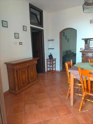 a kitchen and dining room with a table and chairs at Menzel el Emir in Misilmeri