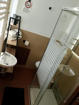 a bathroom with a glass shower and a sink at Mondello suite apartment in Mondello