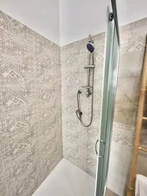 a shower with a glass door in a bathroom at Affittacamere bm in Palermo