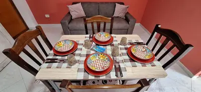 a wooden table with plates and bowls on it at Sweet Dreams a casa di Alex in Palermo