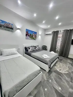 a bedroom with two beds and a window at Home Mia in Palermo