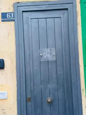 a blue door on a building with a sign on it at Home Mia in Palermo