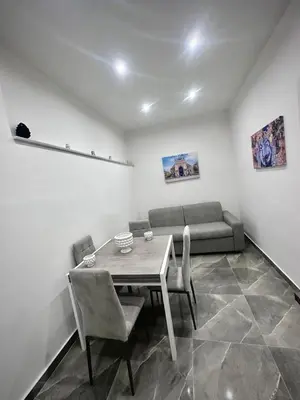 a dining room with a table and chairs and a couch at Home Mia in Palermo