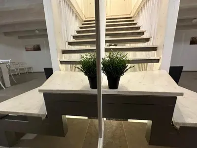 two potted plants sitting on a table with stairs at L'Oasi del Tirreno in Lascari