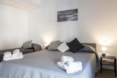 a bedroom with a bed with towels on it at L'Oasi del Tirreno in Lascari