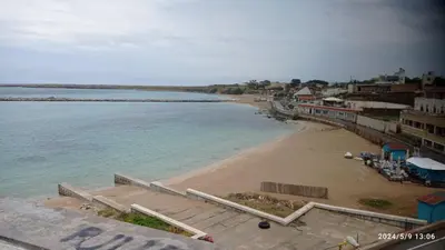 a view of a beach with buildings and the ocean at Casa Atlanna in Terrasini