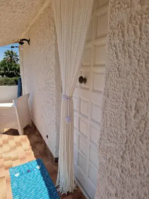 a room with a white door and a curtain at Sizilien 3 in Trappeto