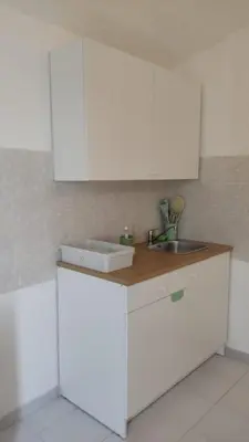 a kitchen with white cabinets and a sink at Sizilien 3 in Trappeto