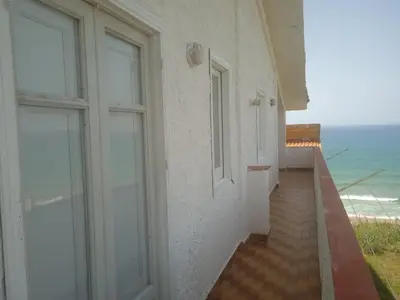 a room with a door and a view of the ocean at Sizilien 3 in Trappeto