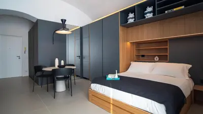 a bedroom with a bed and a table with chairs at Trinacria Marina Apartment in Palermo