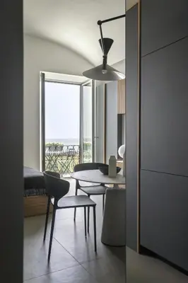 a dining room with a table and chairs and a window at Trinacria Marina Apartment in Palermo