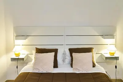 a bedroom with a large bed with two night stands at Cara Palermo in Palermo