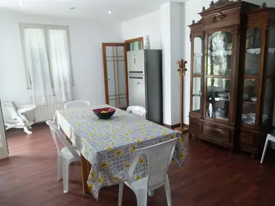 a dining room with a table and a refrigerator at Villa Aurora Appartamento in villa con piscina in Bagheria