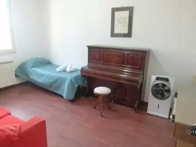 a living room with a piano and a bed at Villa Aurora Appartamento in villa con piscina in Bagheria