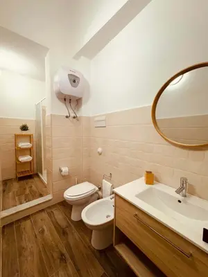 a bathroom with a toilet and a sink and a mirror at RelaxTime Casa Vacanze in Palermo
