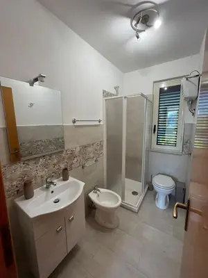 a bathroom with a sink and a shower and a toilet at Anna holidays in Lascari