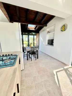 a kitchen and dining room with a table and chairs at Anna holidays in Lascari