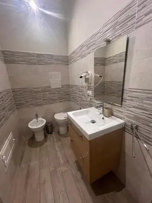 a bathroom with a sink and a toilet and a mirror at Emanuela Home in Palermo