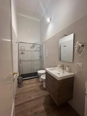 a bathroom with a sink and a toilet and a shower at Emanuela Home in Palermo
