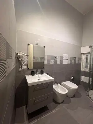 a bathroom with a sink and a toilet at Emanuela Home in Palermo