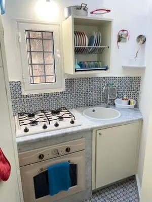 a small kitchen with a stove and a sink at House Quattro Canti in Palermo
